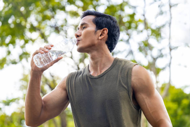 istock Asian man drinking water during jogging exercise at park in the morning. 1479371382