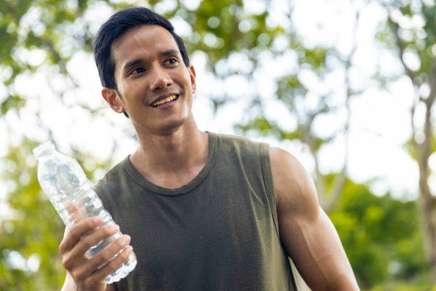 istock Asian man drinking water during jogging exercise at park in the morning. 1479371389