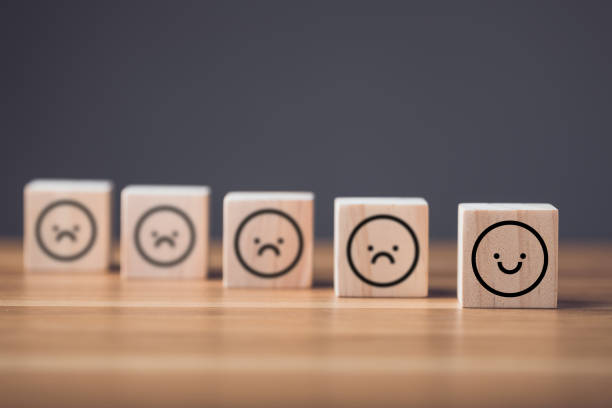 istock Different emotional state concept. Sad face to smile face on wooden blocks cube arranged on wooden table. Idea of manythink to face and smile in finally. 1479371733