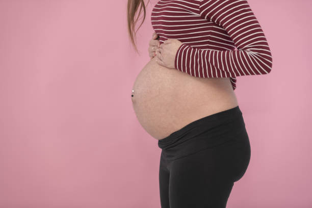 istock Side view of a pregnant woman's exposed belly 1479371925