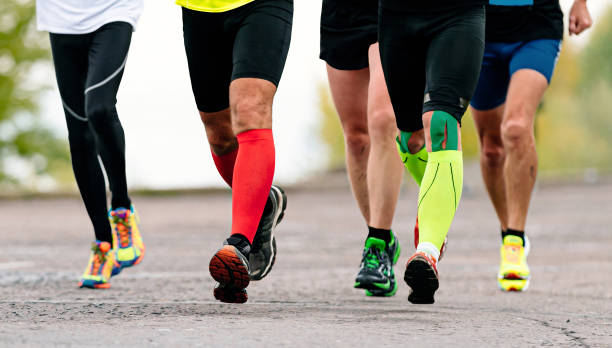 istock group runners athletes running marathon race, front view legs jogger in compression socks and kineso tape knee 1479373071