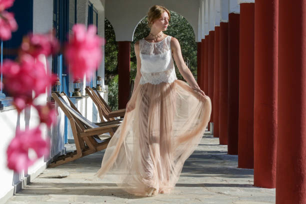 Fashion portrait of woman in white lace top and chiffon long maxi beige skirt, boho wedding outfit, summer vacation fashion Fashion portrait of woman in white lace top and chiffon long maxi beige skirt, boho wedding outfit, summer vacation fashion maxi dress stock pictures, royalty-free photos & images