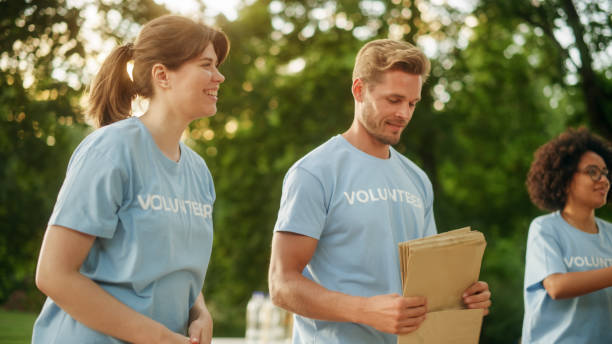 istock Positive Group of Volunteers Preparing Humanitarian Aid and Donations, Loading Boxes in a Cargo Van. Charity Workers Help Members of the Community. Free Meals to Unemployed, Refugees and Immigrants. 1479375092