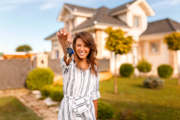 Woman holding her new house keys stock photo