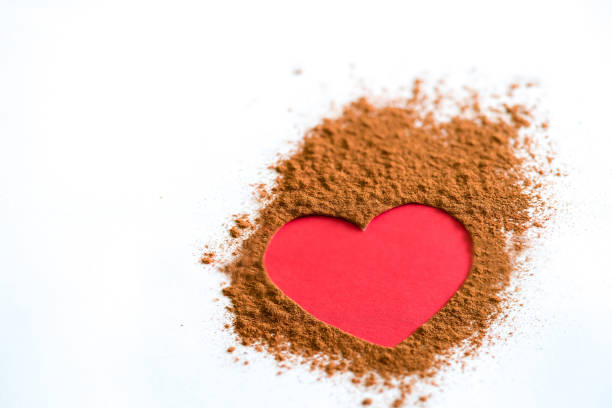 istock Pink heart on brown powder on white bac 1479375621