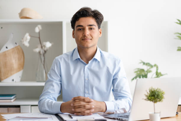 istock Young business man looking at camera in office 1479375667