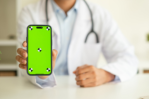 Doctor holding phone screen to camera