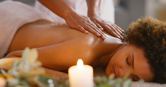 Spa, back and salt scrub massage on woman for zen, physical therapy or skincare. Female client relax with therapist hands for skin exfoliate cosmetics or luxury treatment for health and wellness