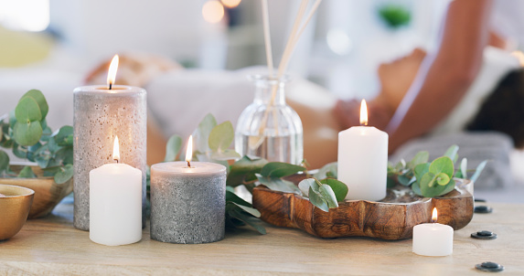 Candle light, interior and natural zen room with essence for calm spiritual wellness or body care at resort. Luxury spa with candles or aromatherapy for beauty cosmetics or physical therapy at salon