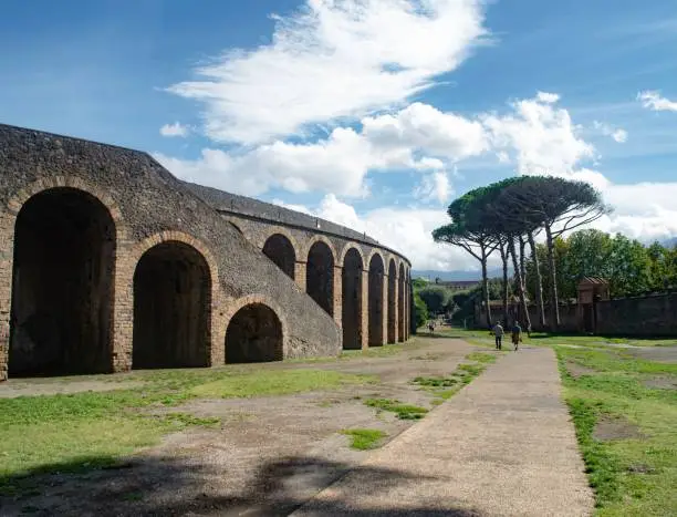 Photo of Group of people walking along a picturesque path in Pompei, Province of Naples, Campania, Italy