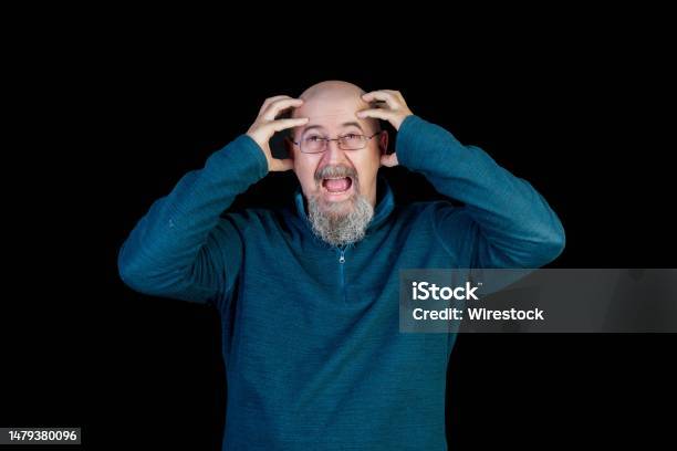 Middleaged Man Suffering From A Severe Headache Or Migraine Isolated On Black Background Stock Photo - Download Image Now