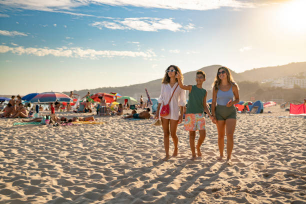 Family on the beach in Sesimbra, Portugal Summer tourism at Praia da California in Sesimbra, Portugal young hot stock pictures, royalty-free photos & images