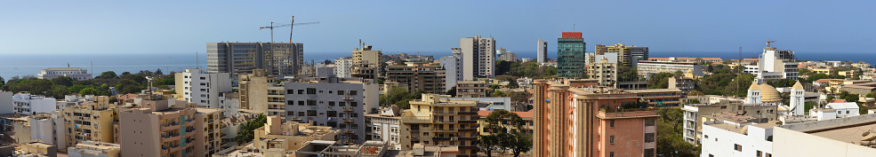 Dakar (Plateau), Senegal: wide panorama of the center of the Senegalese capital, the presential palace can be seen on the left, the large building next to it is the Ministry of the Armed Forces, further to the right is the class-clad Rivonia Tower and below it is the Maginot Building, with the parliament and cathedral further right - Located on the Cape Verde peninsula, on the Atlantic coast of Africa, the city of Dakar was formed around a French fort, replacing the city of Saint Louis as the capital of the French West African colonies in 1902. It was the capital of the Federation of Mali between 1959 and 1960, later becoming the capital of Senegal.