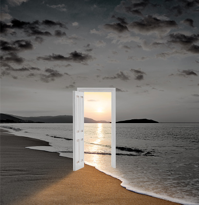 Open door with sunset sea