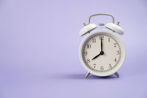 istock Retro alarm clock on purple or violet table background, vintage style, flat lay 1479382204