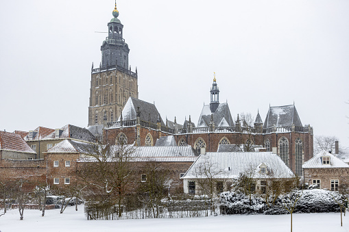 Zutphen, Netherlands – February 08, 2021: SNOW on the rooftops of the Walburgiskerk in Zutphen, The Netherlands, DURING A SNOWSTORM