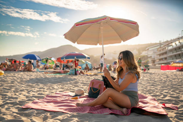 Woman on video call at the beach