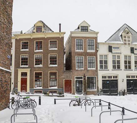 Zutphen, Netherlands – February 08, 2021: Stately mansion exterior facades in historic city center of medieval Hanseatic town during a snowstorm