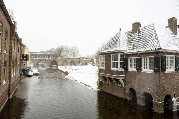 Medieval Hanseatic city during a snowstorm showing remains of the Berkelpoort city wall with the white precipitation in the foreground