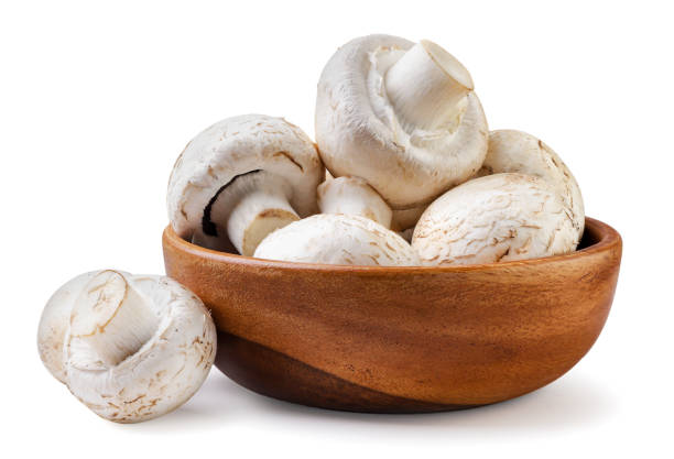istock Champignons in a wooden plate close-up on a white. Isolated 1479390955