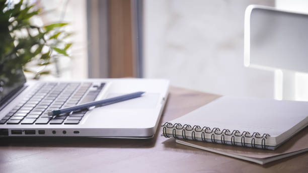 istock Working desk with a laptop, notebooks, and a mobile phone 1479391401