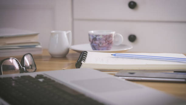 istock Working desk with a laptop, notebooks, and a mobile phone 1479391402
