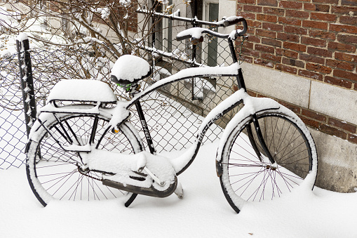 Zutphen, Netherlands – February 08, 2021: Thick pack of snow on single Dutch city bike after a snowstorm in The Netherlands