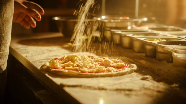 istock In Restaurant Professional Chef Preparing Pizza, Kneading Dough, Adding Ingredients, Cheese, Vegetables, Traditional Family Recipe. Authentic Pizzeria with Delicious Organic Food. Focus on Hands 1479395645