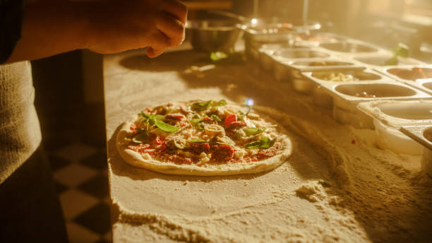 istock In Restaurant Professional Chef Preparing Pizza, Kneading Dough, Adding Ingredients, Cheese, Vegetables, Traditional Family Recipe. Authentic Pizzeria with Delicious Organic Food. Focus on Hands 1479395667
