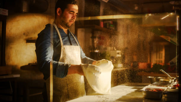 istock In Restaurant Professional Chef Preparing Pizza, Tenderly Working, Kneading Dough, Traditional Family Recipe. Authentic Pizzeria with Deliciously Organic Food. Cinematic Sunny Shot 1479398797