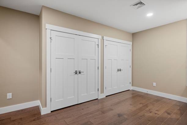 istock Clean empty living room with multiple white and a dark wood floor 1479399593
