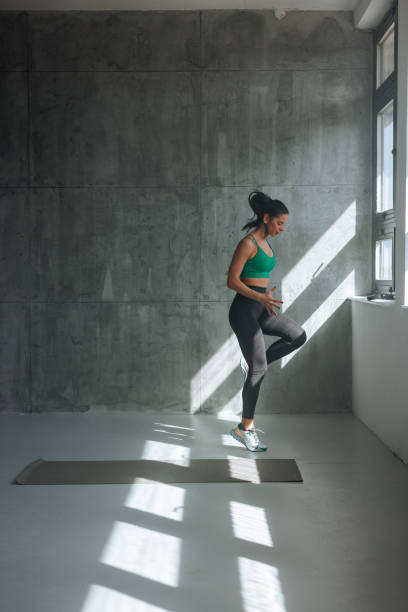 istock Young athletic woman exercising. 1479399725