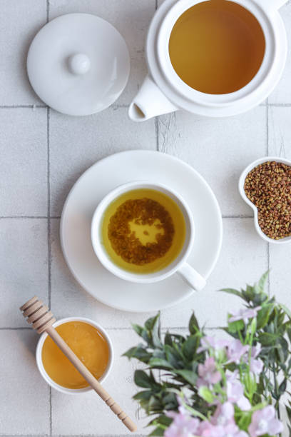 istock Buckwheat tea with honey on the white background with flowers. 1479403010