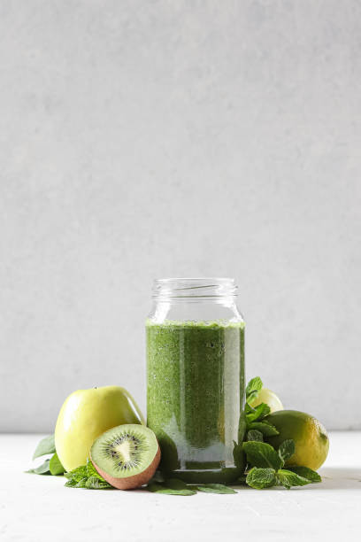 green smoothie, healthy breakfast. - blender apple banana color image imagens e fotografias de stock