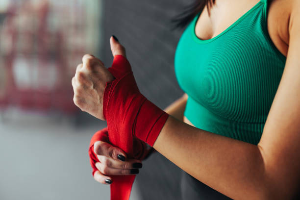 istock Close up on woman bandaging hands for boxing. 1479404737