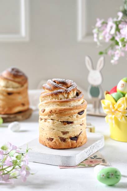 istock Homemade Easter cakes on the white background with eggs and flowers. 1479409474