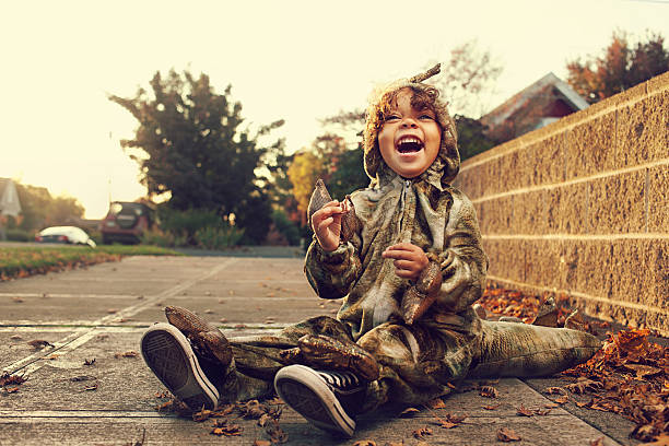 Young boy in dinosaur costume during Halloween