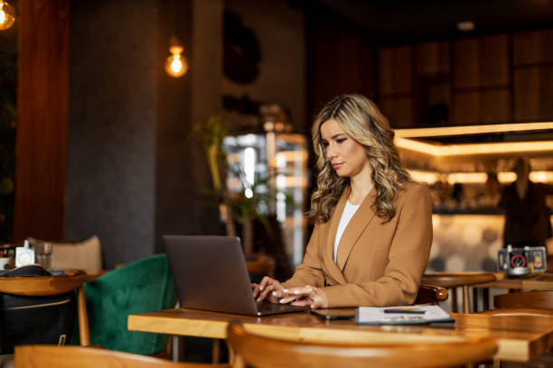 istock Businesswoman at cafe using laptop 1479412668