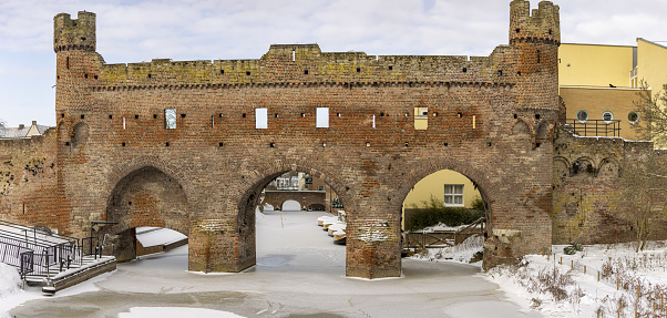 Medieval Berkelpoort entrance portal to historic city centre of Hanseatic Zutphen in The Netherlands in winter after a snow storm