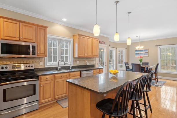 istock Contemporary kitchen features modern hardwood flooring, glossy granite counter tops 1479413862