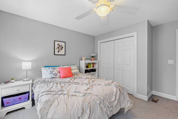 istock White cozy bedroom features a small bed and ceiling fan 1479413910