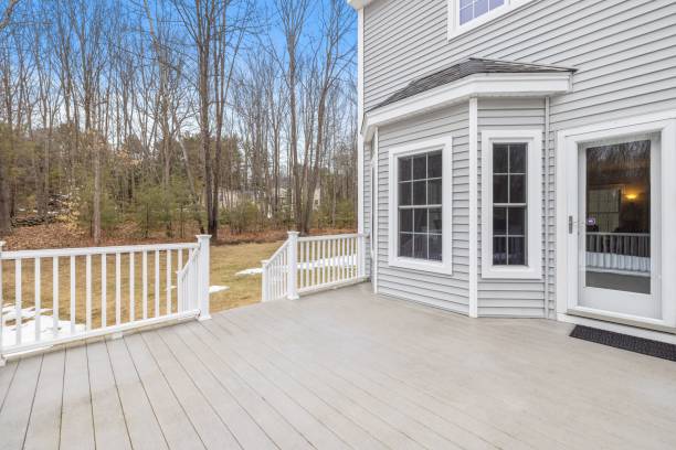 istock Outdoor patio area featuring a large wooden deck with bared trees in the background 1479414037
