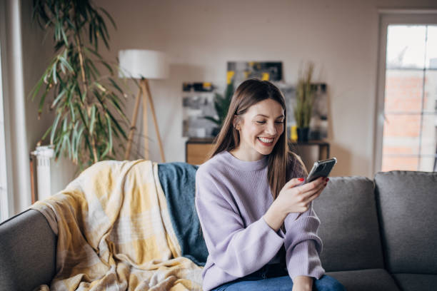 istock Woman using smart phone at home 1479415427