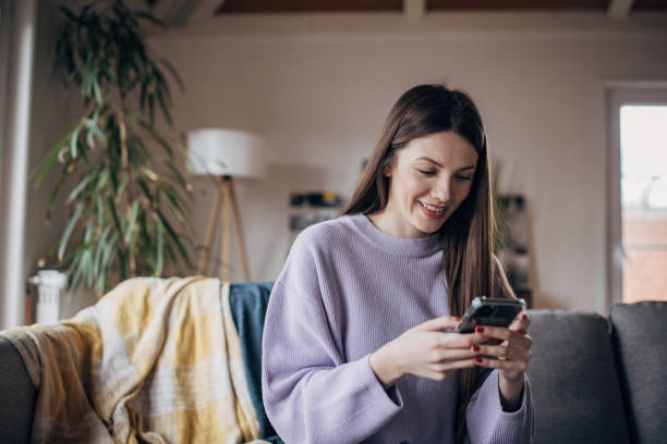 istock Woman using smart phone at home 1479415592