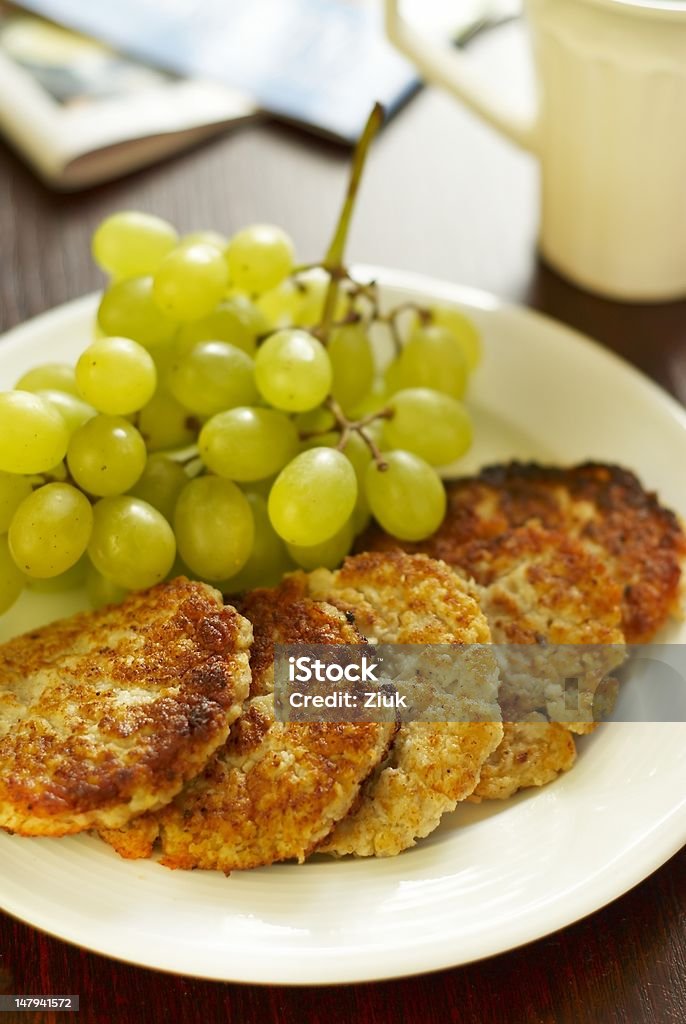 Oatmeal pancakes and grapes Oatmeal pancakes, grapes and tea Baked Stock Photo