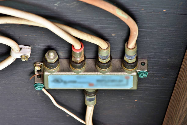 A junction box mounted under a patio roof for cable/satellite cables.