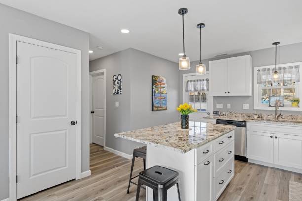 istock Modern kitchen with white walls and cabinets, featuring stainless steel appliances 1479419414