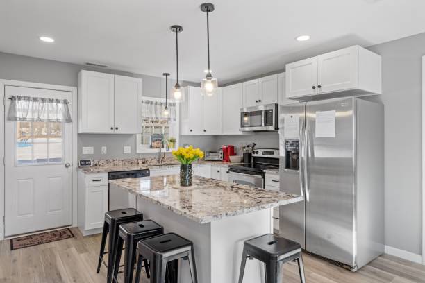 istock Modern kitchen with white walls and cabinets, featuring stainless steel appliances 1479419416
