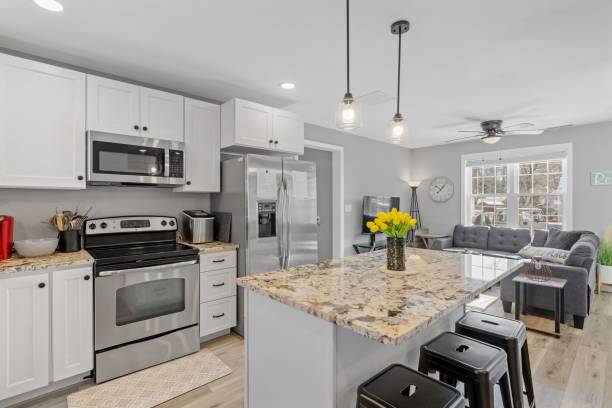 istock Modern kitchen with white walls and cabinets, featuring stainless steel appliances 1479419418