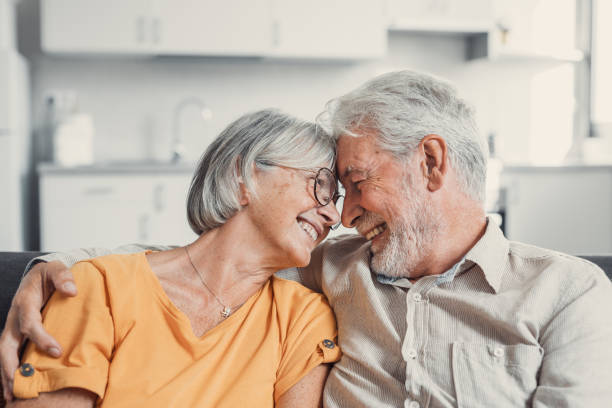 istock Happy laughing older married couple talking, laughing, standing in home interior together, hugging with love, enjoying close relationships, trust, support, care, feeling joy, tenderness 1479419639